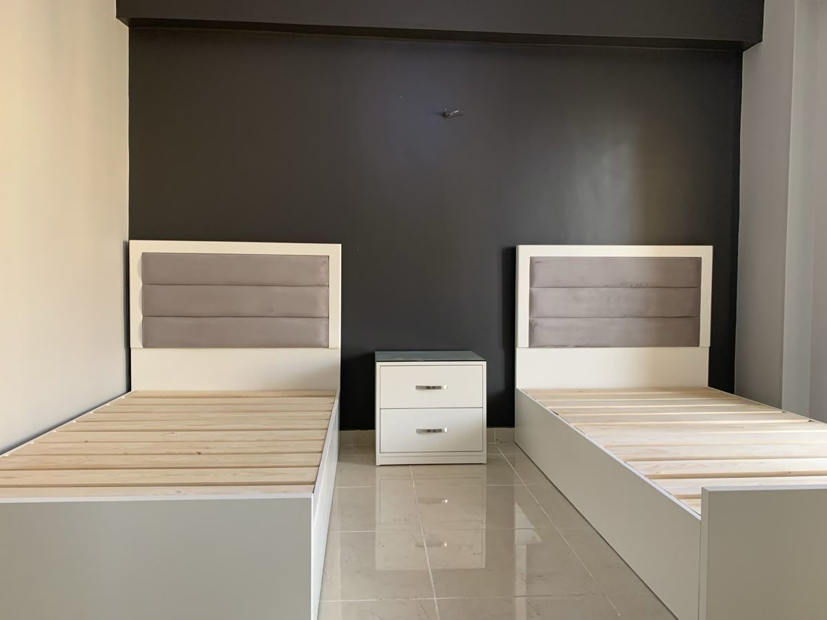 Twin bed with one bedside table